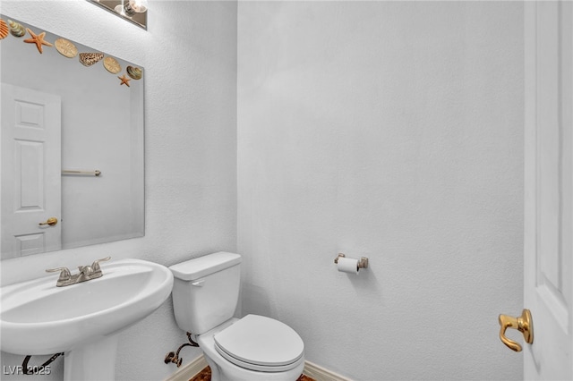 7886 Palace Monaco Ave, Las Vegas, NV 89117 - bathroom with toilet, a sink, and baseboards