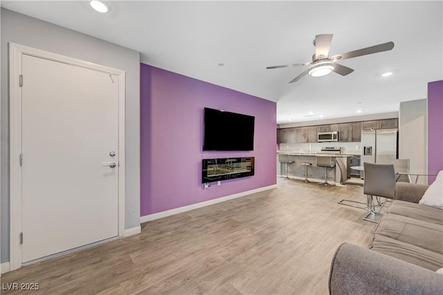 6940 Crescent Gold St, North Las Vegas, NV 89086 - living room with ceiling fan, light wood-type flooring, recessed lighting, and baseboards