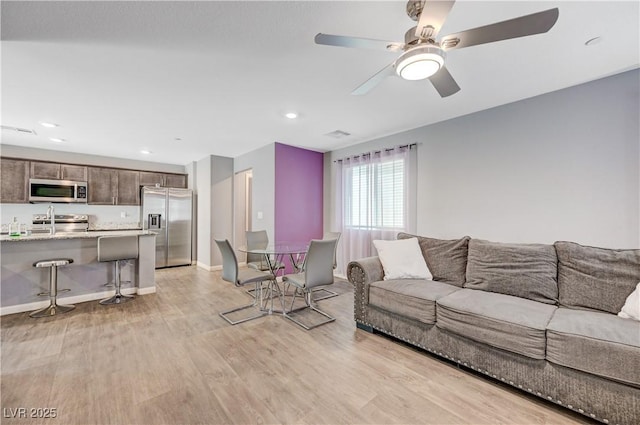 6940 Crescent Gold St, North Las Vegas, NV 89086 - living area featuring light wood-style floors, ceiling fan, baseboards, and recessed lighting