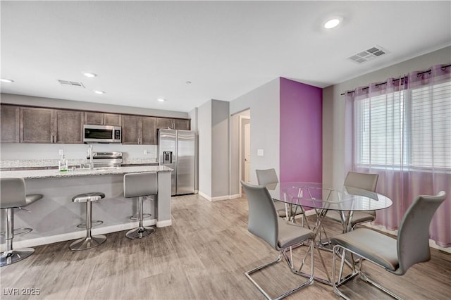 6940 Crescent Gold St, North Las Vegas, NV 89086 - dining space featuring light wood finished floors, baseboards, and recessed lighting