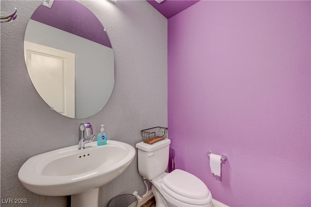 6940 Crescent Gold St, North Las Vegas, NV 89086 - half bath with toilet, a sink, and baseboards