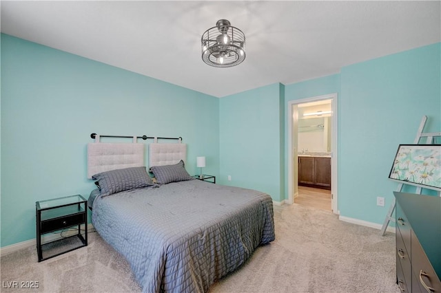 6940 Crescent Gold St, North Las Vegas, NV 89086 - bedroom with light carpet, baseboards, ensuite bathroom, and a chandelier