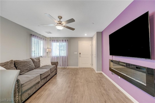6940 Crescent Gold St, North Las Vegas, NV 89086 - living area featuring light wood-type flooring, ceiling fan, and baseboards