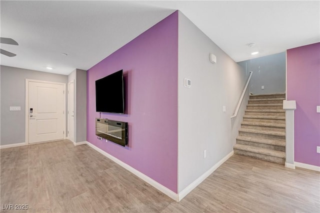 6940 Crescent Gold St, North Las Vegas, NV 89086 - unfurnished living room featuring wood finished floors, stairway, baseboards, a ceiling fan, and recessed lighting