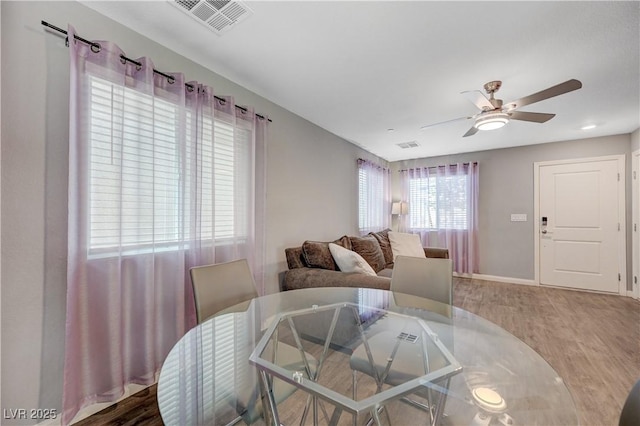 6940 Crescent Gold St, North Las Vegas, NV 89086 - dining room with wood finished floors, ceiling fan, and baseboards