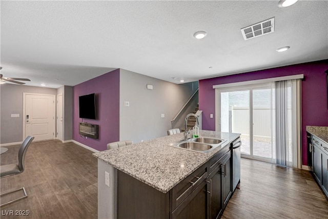 6940 Crescent Gold St, North Las Vegas, NV 89086 - kitchen with a sink, dark wood-style floors, dishwasher, ceiling fan, and a kitchen island with sink