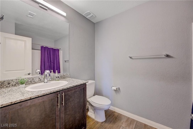 6940 Crescent Gold St, North Las Vegas, NV 89086 - full bath with wood finished floors, vanity, toilet, baseboards, and curtained shower