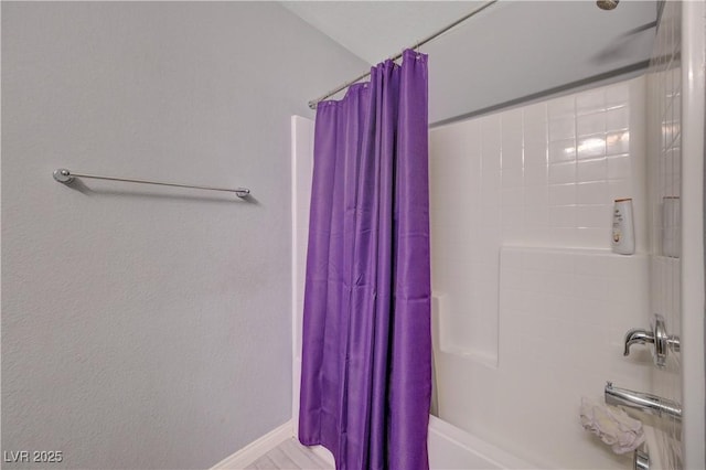 6940 Crescent Gold St, North Las Vegas, NV 89086 - bathroom featuring shower / tub combo with curtain and baseboards