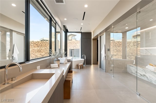 4 Horseshoe Rock Ct, Henderson, NV 89012 - bathroom with a freestanding bath, double vanity, a marble finish shower, tile patterned floors, and recessed lighting
