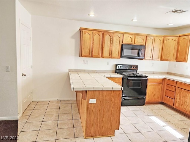 1951 Teepee Rd, Pahrump, NV 89048 - kitchen with black appliances, tile countertops, light tile patterned floors, recessed lighting, and a peninsula