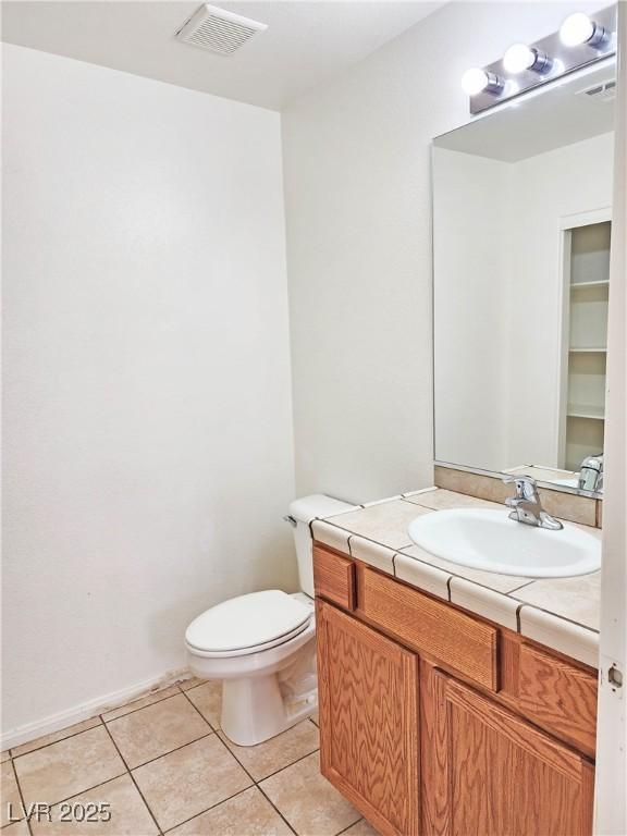1951 Teepee Rd, Pahrump, NV 89048 - half bath featuring vanity, toilet, and tile patterned floors
