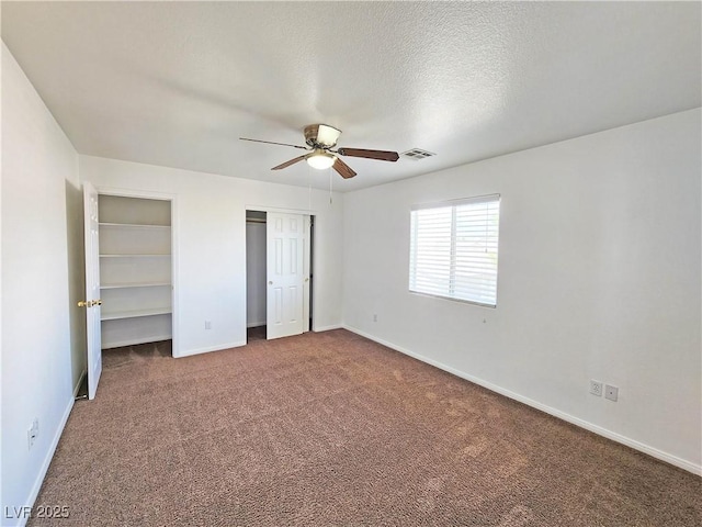 1951 Teepee Rd, Pahrump, NV 89048 - unfurnished bedroom featuring carpet, two closets, baseboards, ceiling fan, and a textured ceiling
