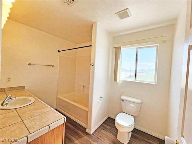 1951 Teepee Rd, Pahrump, NV 89048 - full bathroom with toilet, wood finished floors, vanity, shower / tub combination, and baseboards