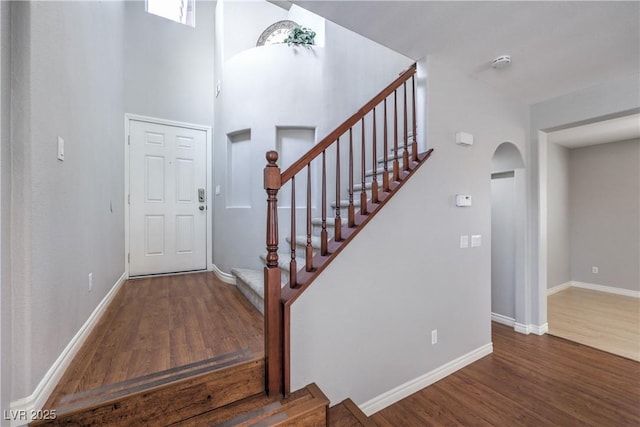 9005 Semillon St, Las Vegas, NV 89148 - entryway featuring arched walkways, wood finished floors, stairs, baseboards, and a high ceiling