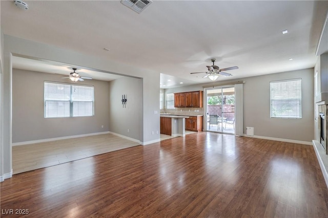 9005 Semillon St, Las Vegas, NV 89148 - unfurnished living room with ceiling fan, baseboards, and wood finished floors