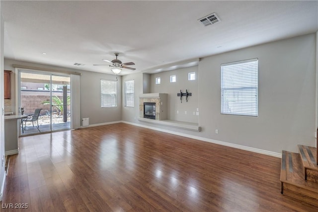 9005 Semillon St, Las Vegas, NV 89148 - unfurnished living room with a ceiling fan, wood finished floors, baseboards, and a tile fireplace