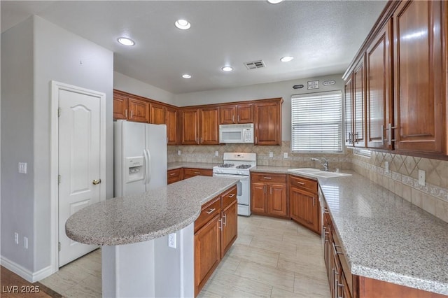 9005 Semillon St, Las Vegas, NV 89148 - kitchen featuring white appliances, a sink, decorative backsplash, a center island, and brown cabinetry