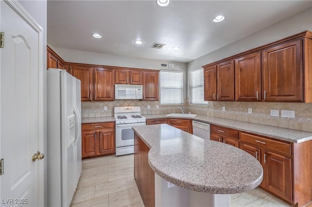 9005 Semillon St, Las Vegas, NV 89148 - kitchen with white appliances, a sink, decorative backsplash, a kitchen island, and recessed lighting
