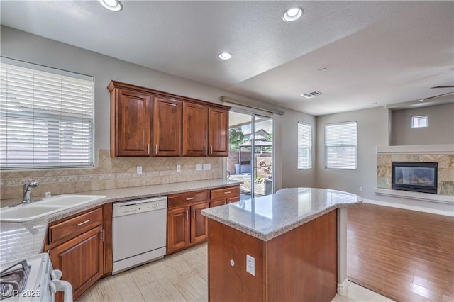 9005 Semillon St, Las Vegas, NV 89148 - kitchen featuring dishwasher, a sink, range, a kitchen island, and decorative backsplash