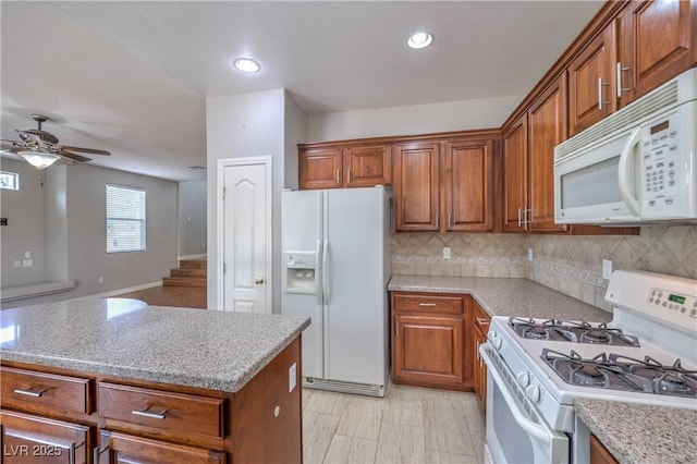 9005 Semillon St, Las Vegas, NV 89148 - kitchen featuring white appliances, brown cabinetry, a ceiling fan, decorative backsplash, and recessed lighting