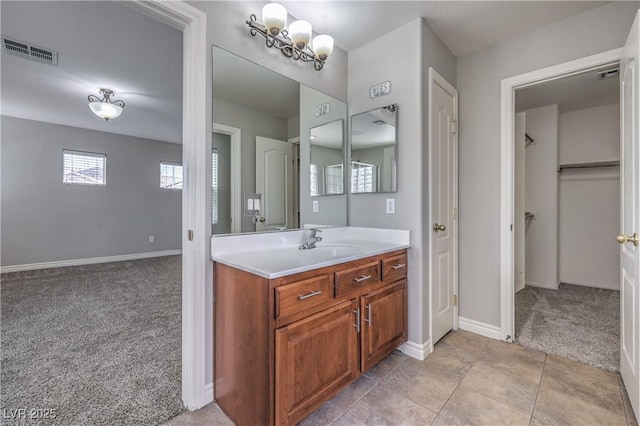 9005 Semillon St, Las Vegas, NV 89148 - bathroom with vanity, baseboards, a spacious closet, and a chandelier