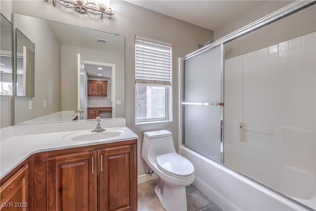 9005 Semillon St, Las Vegas, NV 89148 - full bathroom featuring vanity, toilet, bath / shower combo with glass door, tile patterned floors, and healthy amount of natural light