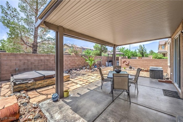 9005 Semillon St, Las Vegas, NV 89148 - fenced backyard with a covered hot tub, central AC, outdoor dining area, and a patio