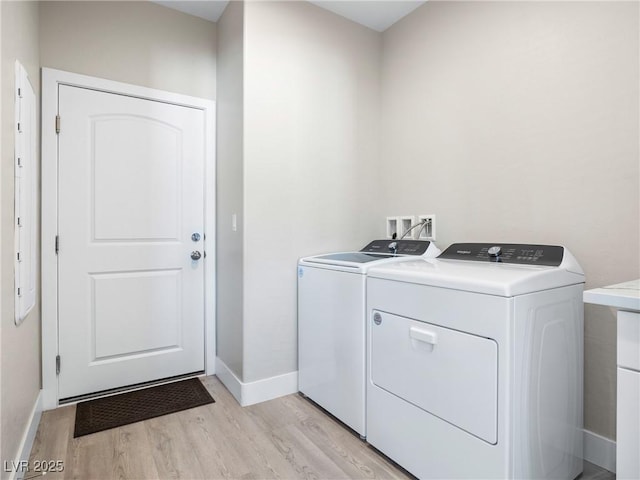 1500 E Laguna St, Pahrump, NV 89048 - washroom with washer and clothes dryer, light wood-style flooring, and baseboards