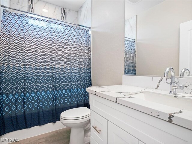 1500 E Laguna St, Pahrump, NV 89048 - bathroom with vanity, toilet, and wood finished floors