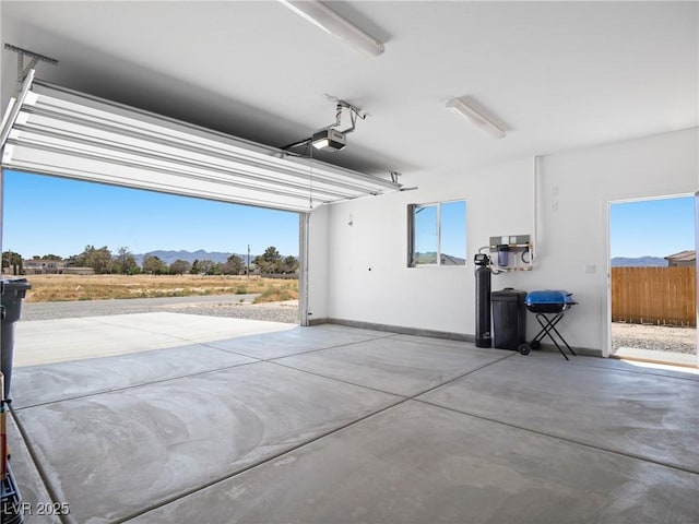 1500 E Laguna St, Pahrump, NV 89048 - garage with a mountain view, baseboards, and a garage door opener