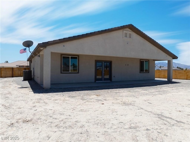 1500 E Laguna St, Pahrump, NV 89048 - rear view of house featuring stucco siding, central AC unit, and a patio area