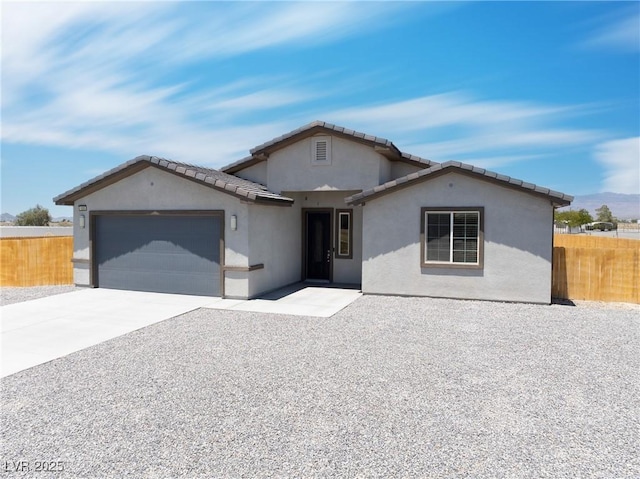 1500 E Laguna St, Pahrump, NV 89048 - ranch-style home with an attached garage, driveway, stucco siding, and a tile roof