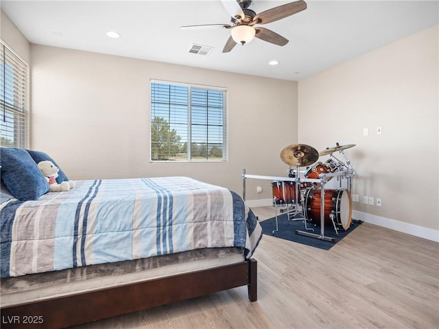 1500 E Laguna St, Pahrump, NV 89048 - bedroom with multiple windows, baseboards, wood finished floors, recessed lighting, and ceiling fan