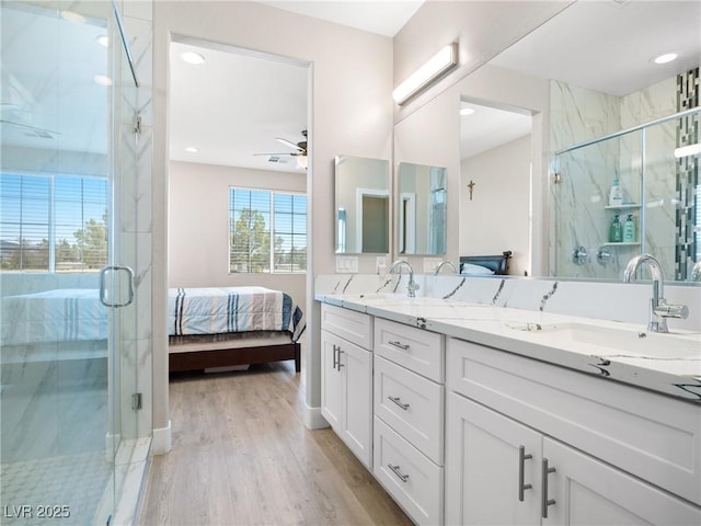 1500 E Laguna St, Pahrump, NV 89048 - ensuite bathroom with double vanity, ceiling fan, wood finished floors, a marble finish shower, and recessed lighting