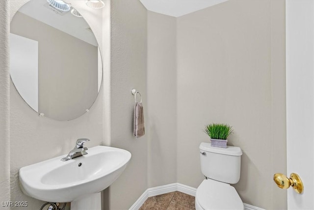 11022 Saint Rafael St, Las Vegas, NV 89141 - bathroom with toilet, baseboards, a sink, and tile patterned floors