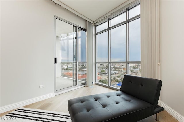 200 W Sahara Ave Unit 910, Las Vegas, NV 89102 - sitting room with healthy amount of natural light, expansive windows, wood finished floors, and baseboards