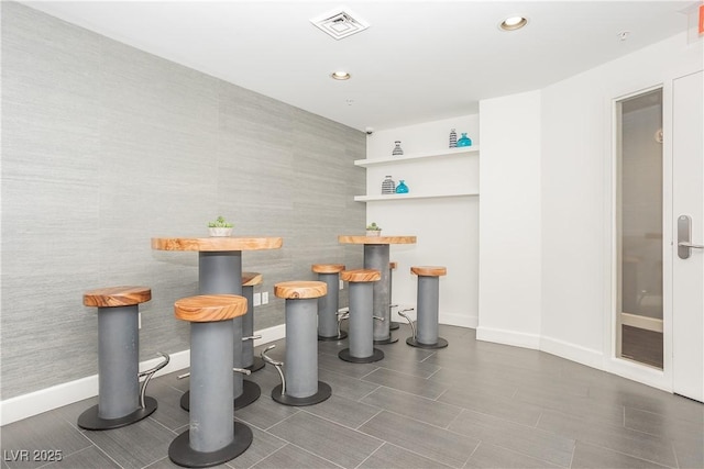 200 W Sahara Ave Unit 910, Las Vegas, NV 89102 - dining area with baseboards, a dry bar, recessed lighting, and wood finished floors
