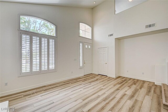 301 Lakewood Garden Dr, Las Vegas, NV 89148 - foyer entrance featuring light wood-style flooring, baseboards, and a towering ceiling