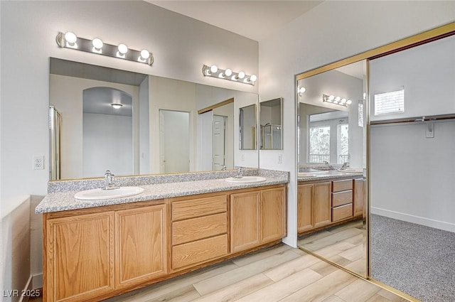 301 Lakewood Garden Dr, Las Vegas, NV 89148 - full bathroom featuring double vanity and wood finished floors