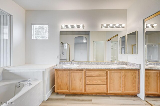 301 Lakewood Garden Dr, Las Vegas, NV 89148 - bathroom featuring double vanity, a bath, wood finished floors, and a shower