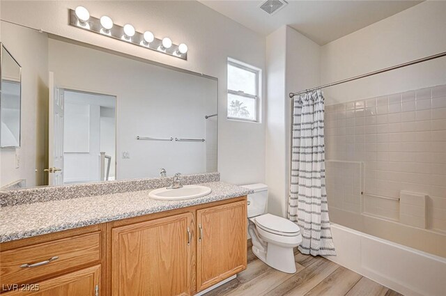 301 Lakewood Garden Dr, Las Vegas, NV 89148 - bathroom featuring toilet, wood finished floors, vanity, and shower / tub combo with curtain