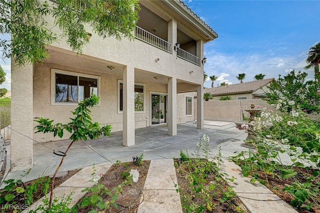 301 Lakewood Garden Dr, Las Vegas, NV 89148 - rear view of property featuring stucco siding, a balcony, and a patio