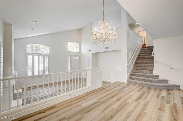 301 Lakewood Garden Dr, Las Vegas, NV 89148 - foyer featuring wood finished floors, a chandelier, high vaulted ceiling, and stairs