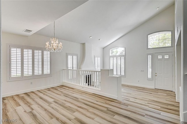 301 Lakewood Garden Dr, Las Vegas, NV 89148 - entryway with high vaulted ceiling, light wood finished floors, a chandelier, healthy amount of natural light, and baseboards