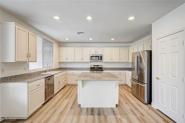 301 Lakewood Garden Dr, Las Vegas, NV 89148 - kitchen featuring stainless steel appliances, a sink, a kitchen island, light stone counters, and recessed lighting
