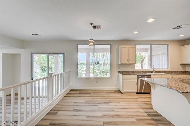 301 Lakewood Garden Dr, Las Vegas, NV 89148 - kitchen featuring dishwasher, a sink, light stone counters, light wood-style flooring, and recessed lighting