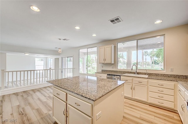 301 Lakewood Garden Dr, Las Vegas, NV 89148 - kitchen with a sink, light wood finished floors, a center island, light stone counters, and recessed lighting