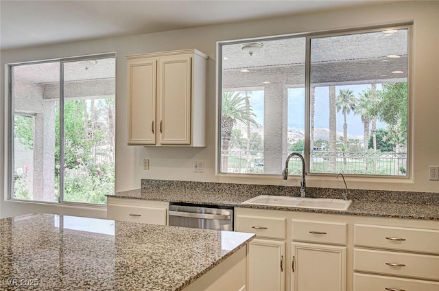 301 Lakewood Garden Dr, Las Vegas, NV 89148 - kitchen featuring dishwasher, a sink, healthy amount of natural light, and stone counters