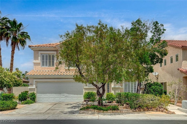 301 Lakewood Garden Dr, Las Vegas, NV 89148 - mediterranean / spanish-style house with a tile roof, driveway, an attached garage, and stucco siding