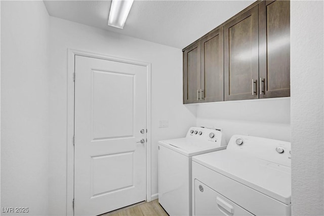 7756 Seville Estates Ct, Las Vegas, NV 89113 - washroom with washing machine and dryer, cabinet space, and light wood-style floors